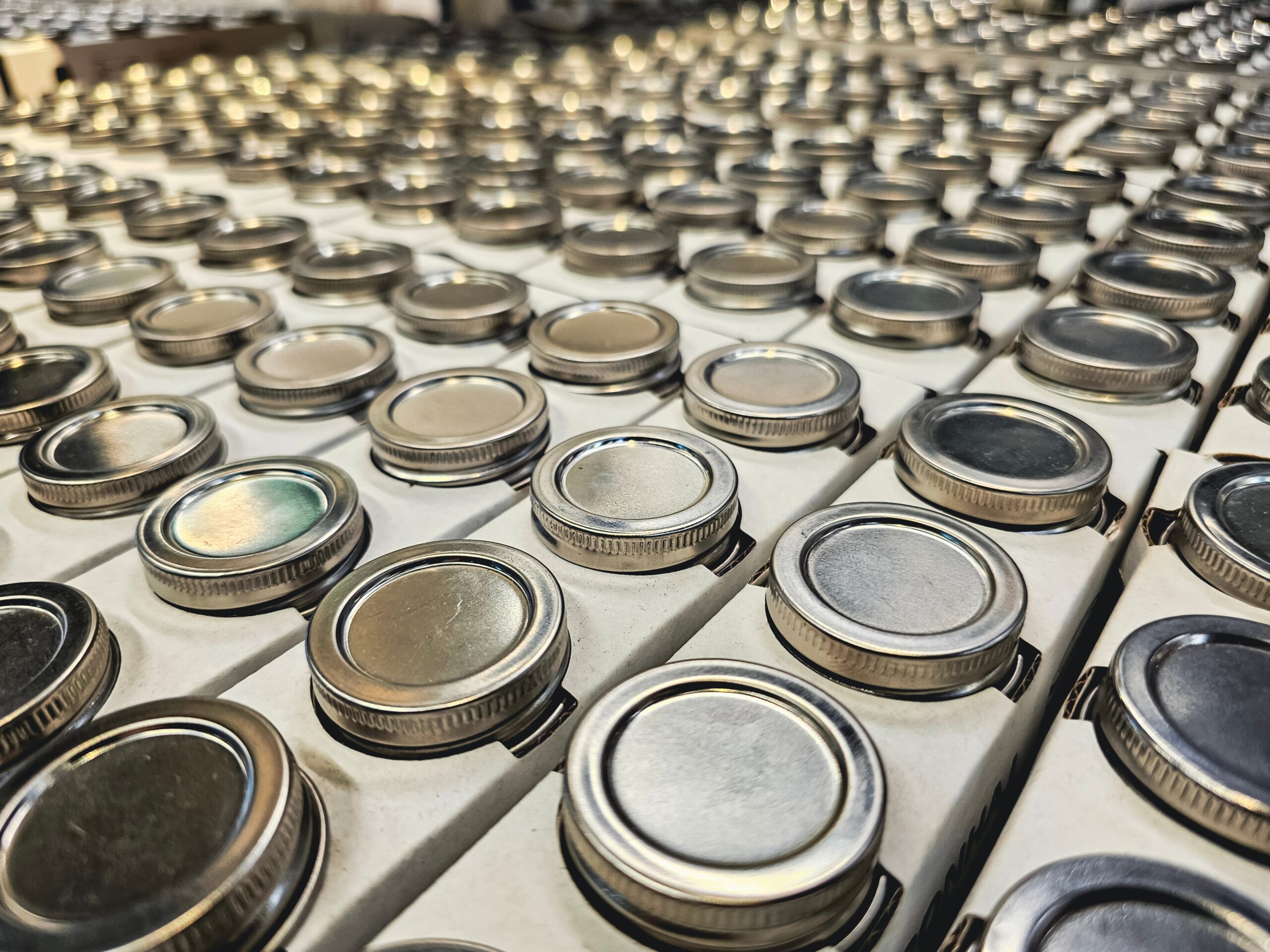 Stacks,Of,Raw,Of,Iron,Lids,Of,A,Glass,Jars